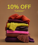 A promotional graphic showing a stack of folded knit sweaters in multiple colors, including rust orange, plum, yellow, charcoal, pink, brown, and purple, on a warm tan background with large yellow text reading '10% OFF TUESDAY *'.